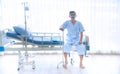 Asian sick or elderly old man sitting alone on the patient`s bed