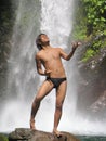 Asian singer under waterfall Royalty Free Stock Photo