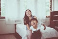 Asian single mom and carrying her cheerful daughter at home together,Happy and funny