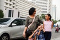 Asian Single Mother with Three Children Having Fun Traveling Around At City Center Looking At City Scene Royalty Free Stock Photo