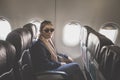 Asian single woman on passenger seat of airplane