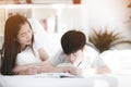 Asian sister and brother relaxing and playing on ther bed. Royalty Free Stock Photo