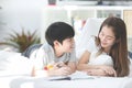 Asian sister and brother relaxing and playing on ther bed. Royalty Free Stock Photo