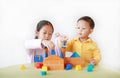 Asian sister and her little brother playing wood block toy together. Little Boy and girl doing activity over white background Royalty Free Stock Photo