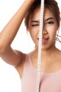 Asian slim girl wink her eye with measuring tape Royalty Free Stock Photo