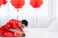 Asian smart young father feed his adorable son baby in bed  healthy fatherhood happy play with infant while feeding both father Royalty Free Stock Photo