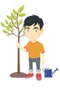 Asian smiling boy planting a tree. Royalty Free Stock Photo
