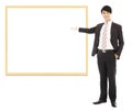 Asian smiling business man pointing blank board Royalty Free Stock Photo