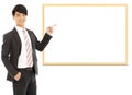 Asian smiling businessman pointing blank board Royalty Free Stock Photo