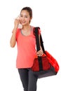 Asian Smiling fit young woman with gym bag standing ready for fitness exercise. Royalty Free Stock Photo