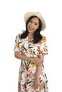 Asian smiling girl in summer casual floral dress and white straw