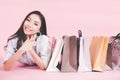 Asian smiling woman so happy with her shopping in casual clothing with shopping bags on the wall pink background, Vintage tone. Royalty Free Stock Photo