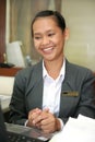 Asian smiling at work