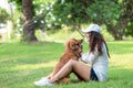 Asian smilling lifestyle woman playing and happy with golden retriever friendship dog in sunrise Royalty Free Stock Photo