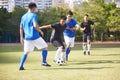 Asian soccer players playing on field