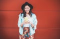 Asian social influencer woman using smartphone with coral background - Happy chinese girl having fun with new trends technology -