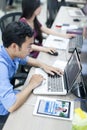 Asian Software Developer Using Laptop Computer