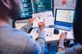 Asian software developers teams working on multiple screens displaying code and application diagrams at night in modern office