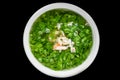 Asian soup made of spinach and seafood with shrimps isolated on black background top view Royalty Free Stock Photo