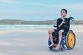 Asian special child on wheelchair playing doing activity vacation on sea beach in summer Royalty Free Stock Photo