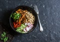 Asian spicy fried chicken in a spicy sauce with noodles and fresh vegetables on dark background Royalty Free Stock Photo