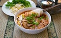 Asian spicy noodle soup with chopstick hold on noodle with pork Royalty Free Stock Photo