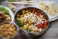 Asian spicy soup with vegetables, seafood and germinated soybean sprouts in a bowl close-up, top view. Gastronomic