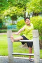 Asian sport boy stretching on iron bar in garden Royalty Free Stock Photo