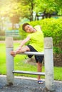 Asian sport boy stretching on iron bar in garden Royalty Free Stock Photo