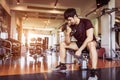 Asian sport man lifting dumbbell at fitness bench with gym equipment background. Sport exercise and People lifestyles concept