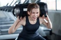 asian sport woman in sportswear exercise squat with with training weight bag in fitness gym . young girl workout with lifting wei Royalty Free Stock Photo