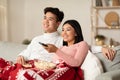 Asian Spouses Enjoying Christmas Eve Watching TV In Living Room Royalty Free Stock Photo