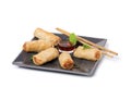 Asian spring rolls and sauce on white background