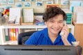 Asian staff or employee receive phone call from customer and smile also look to camera with happy emotion. Concept of good service