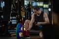 Asian staff trainer is doing daily cleaning the barbell in his gym for cleanliness and sanitize for hygiene and disease infection