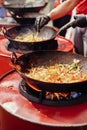 Asian street food festival in city. Chef cooking noodles and vegetables in a pan on fire. Fried chinese japanese noodles with Royalty Free Stock Photo