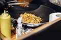 Asian street food festival in city. Chef cooking noodles and vegetables in a pan on fire. Fried chinese japanese noodles with Royalty Free Stock Photo