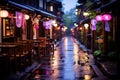 an asian street lined with tables and chairs in the rain