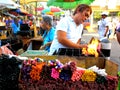 Asian street vendor selling colored candles outside of quiapo church in quiapo, manila, philippines in asia