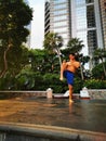 Asian muscular strong active man Tdoing thai boxing in a park