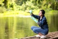 Asian student biology taking and testing sample of natural river water.  Experts science women keep water for research analysis in Royalty Free Stock Photo