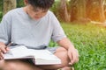 Asian Student boy elementary sitting reading and doing his homework for learning study at home outdoor. Studying in Education Royalty Free Stock Photo