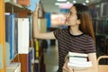 Student choosing book in the shelf in library Royalty Free Stock Photo