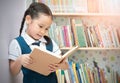 Asian student cute girl reading book in library Royalty Free Stock Photo