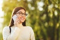 Asian student girl talking on phone in city park Royalty Free Stock Photo