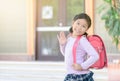 Asian student going to school and waving goodbye Royalty Free Stock Photo