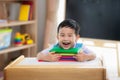 Asian student happy after back to school and smile in his class room in preschool Royalty Free Stock Photo