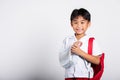 Asian student kid boy wearing student thai uniform accident broken bone wearing splint arm plaster fiberglass cast covering arm in