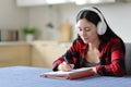 Asian student listening lesson and taking notes Royalty Free Stock Photo