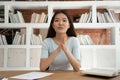 Asian student sit at desk in library filming educational vlog